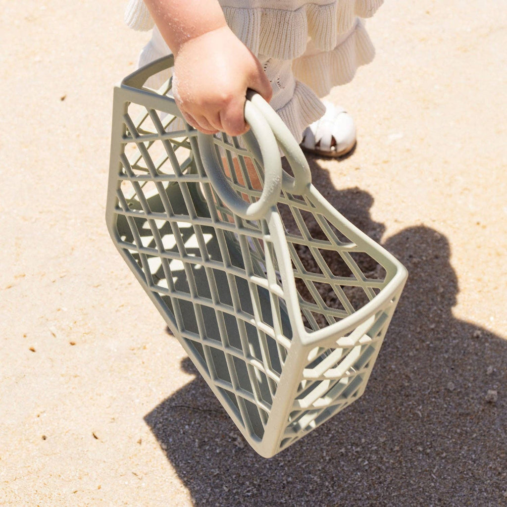 A person holding a green silicone  bag.