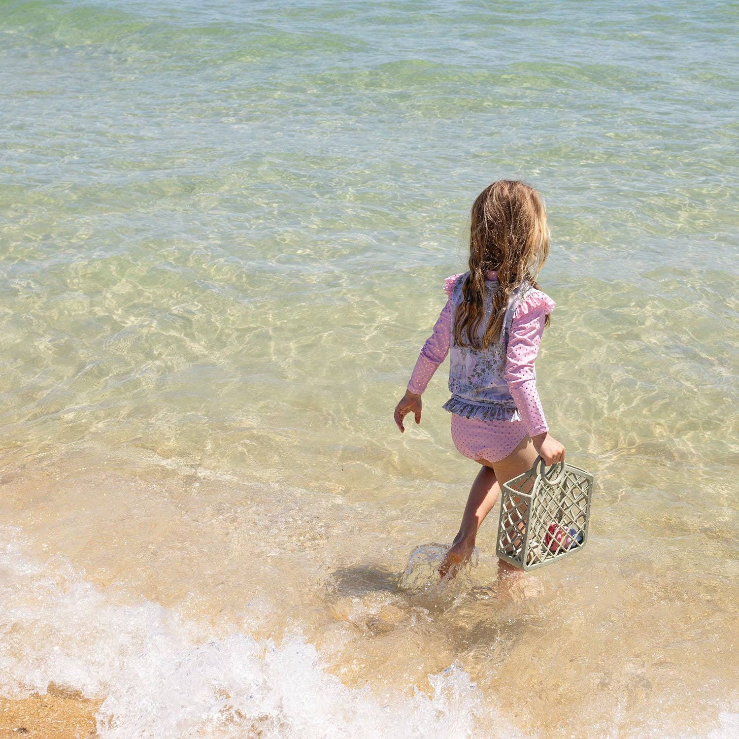 Child at the beach with sage silicone bag