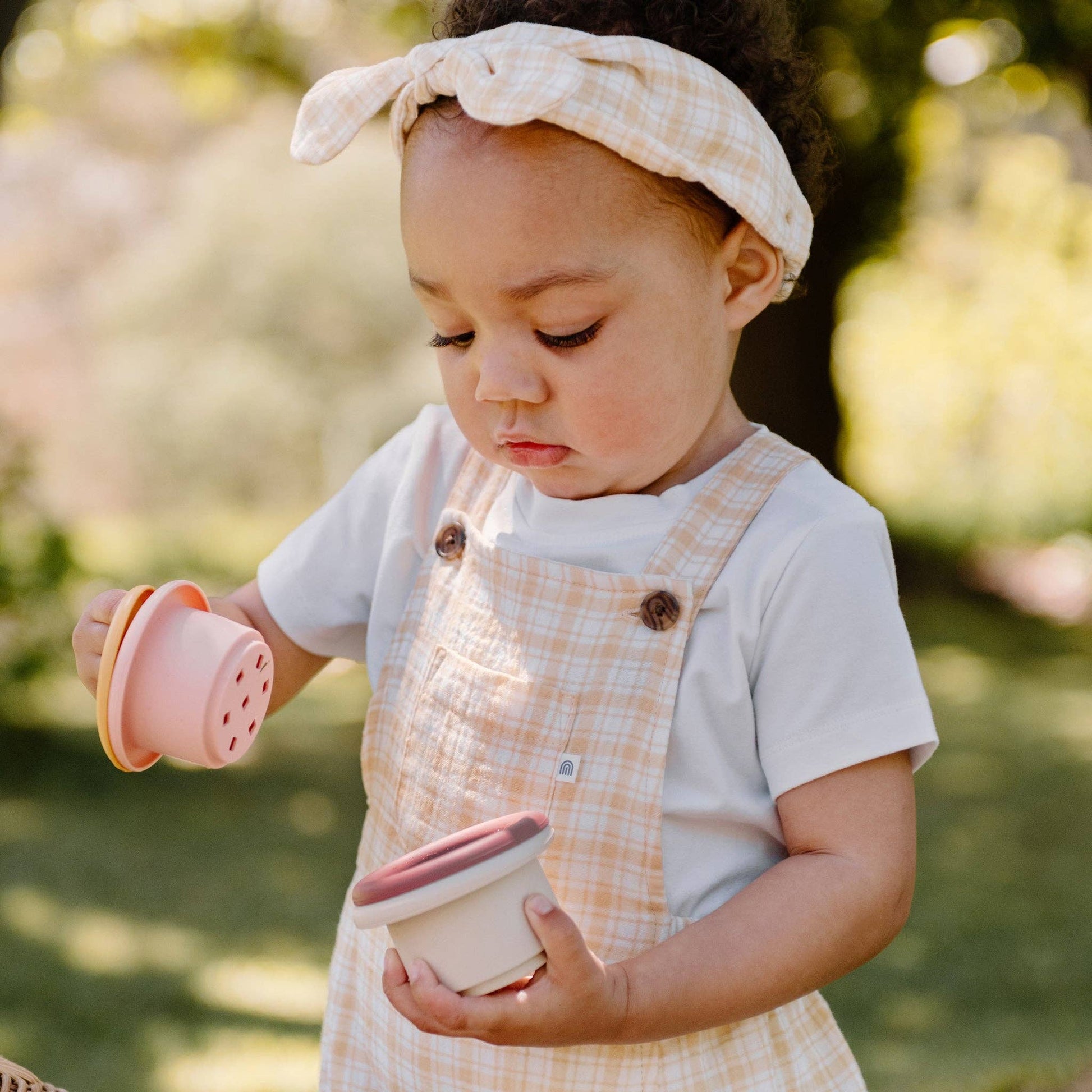 Child holding Kynd Baby - Stacking Cups - Silicone