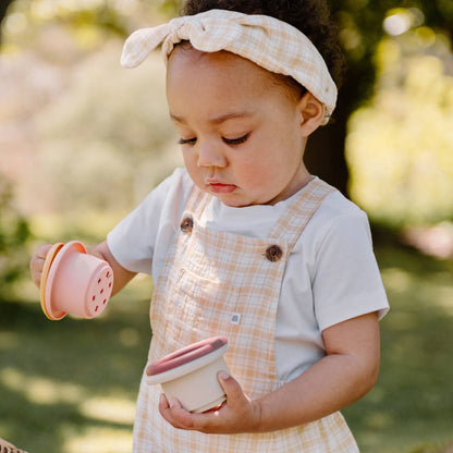 Child holding Kynd Baby - Stacking Cups - Silicone