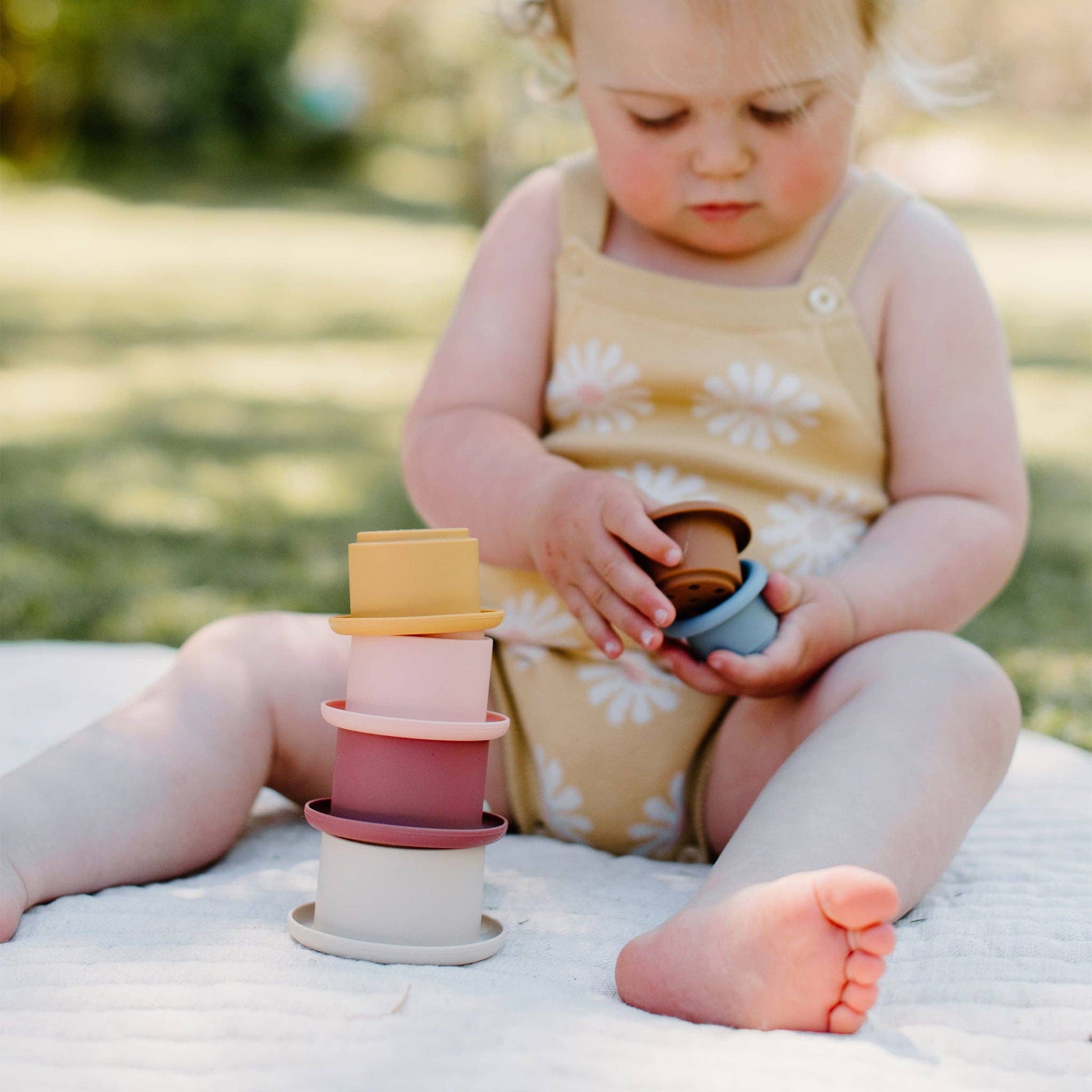Child holding Kynd Baby - Stacking Cups - Silicone