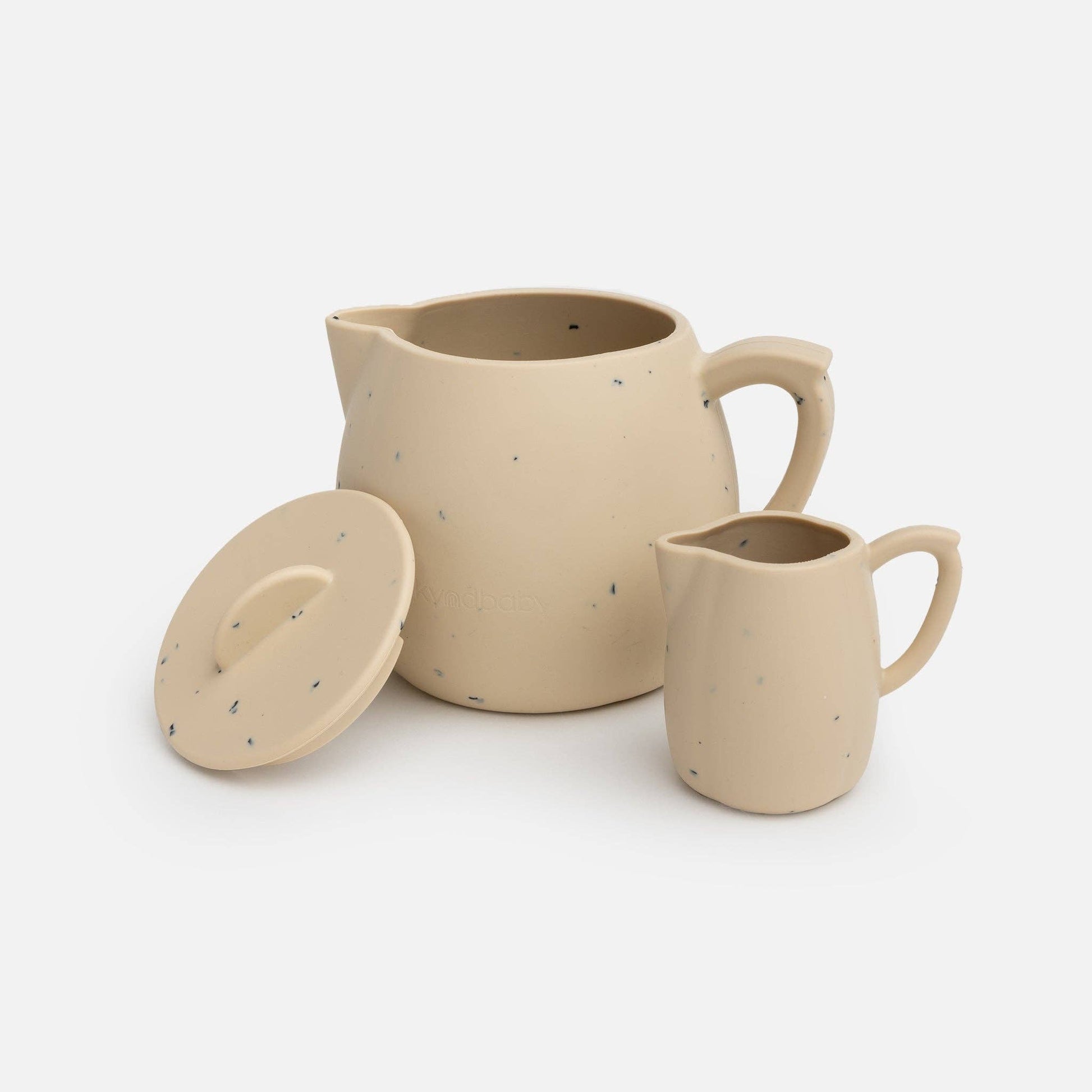 Silicone beige teapot and milk jug on a white background.