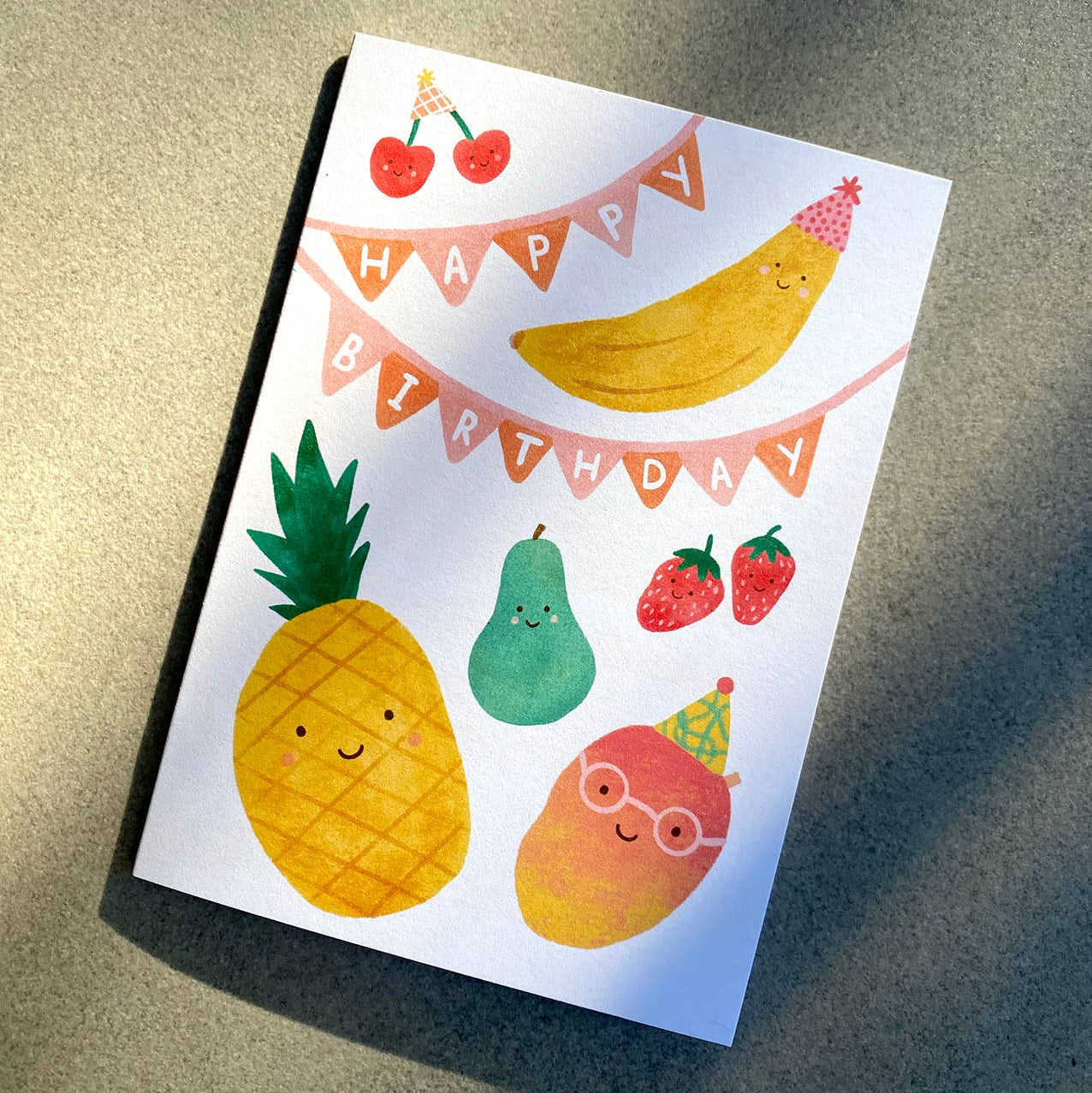 Birthday card with fruit illustrations on a textured surface