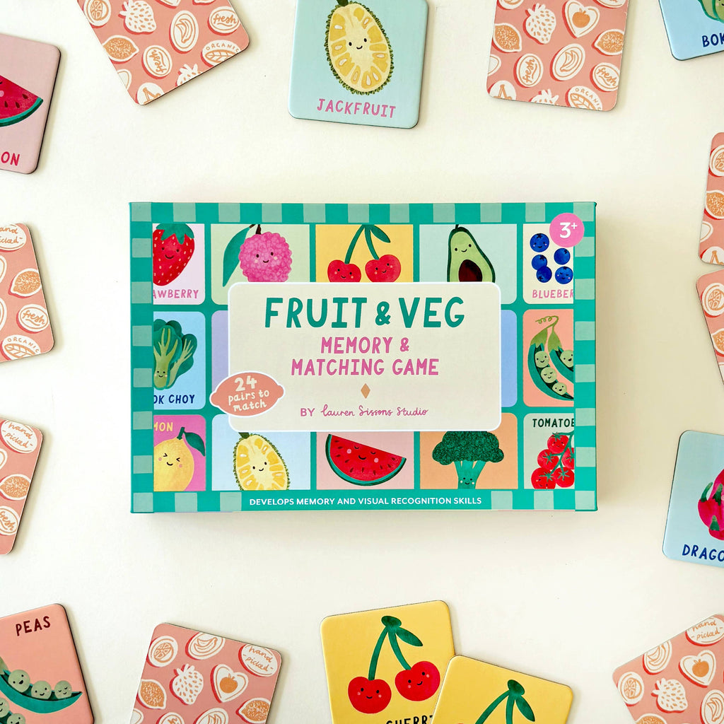 Fruit and veg memory matching game box surrounded by colorful game cards on a light background