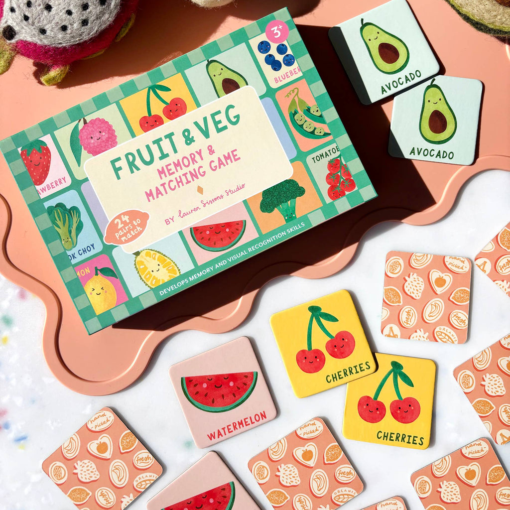 Memory game with fruit and vegetable cards on a colorful surface