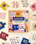 Number puzzle pairs set with colorful packaging on a light background