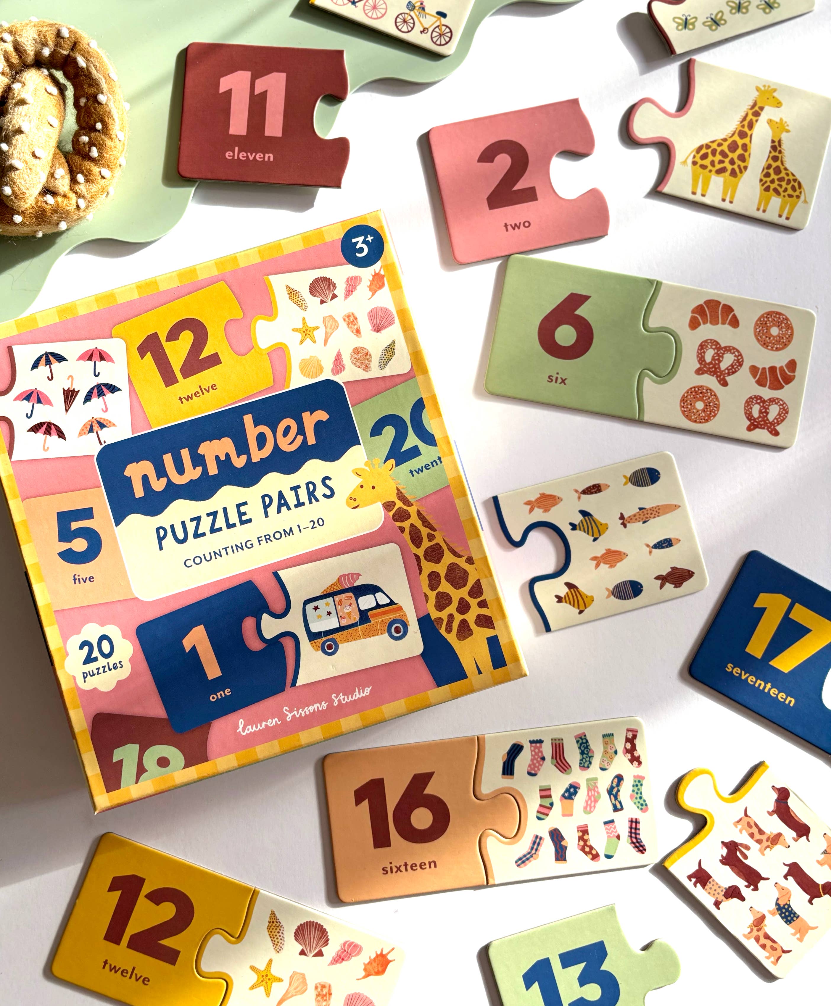 Number puzzle pairs set with colorful packaging on a white surface