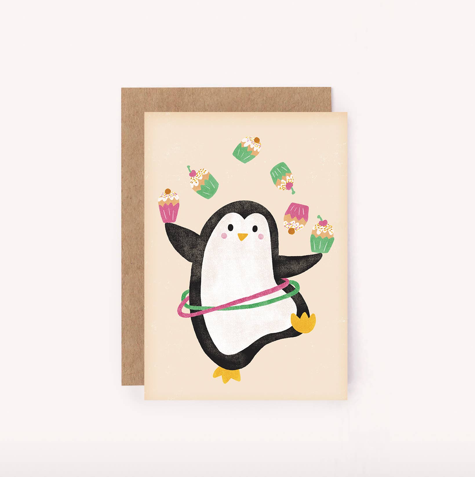 Greeting card with a penguin holding a hula hoop and cupcakes on a beige background