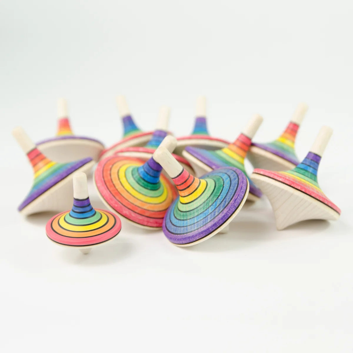 Colorful wooden spinning tops on a white background