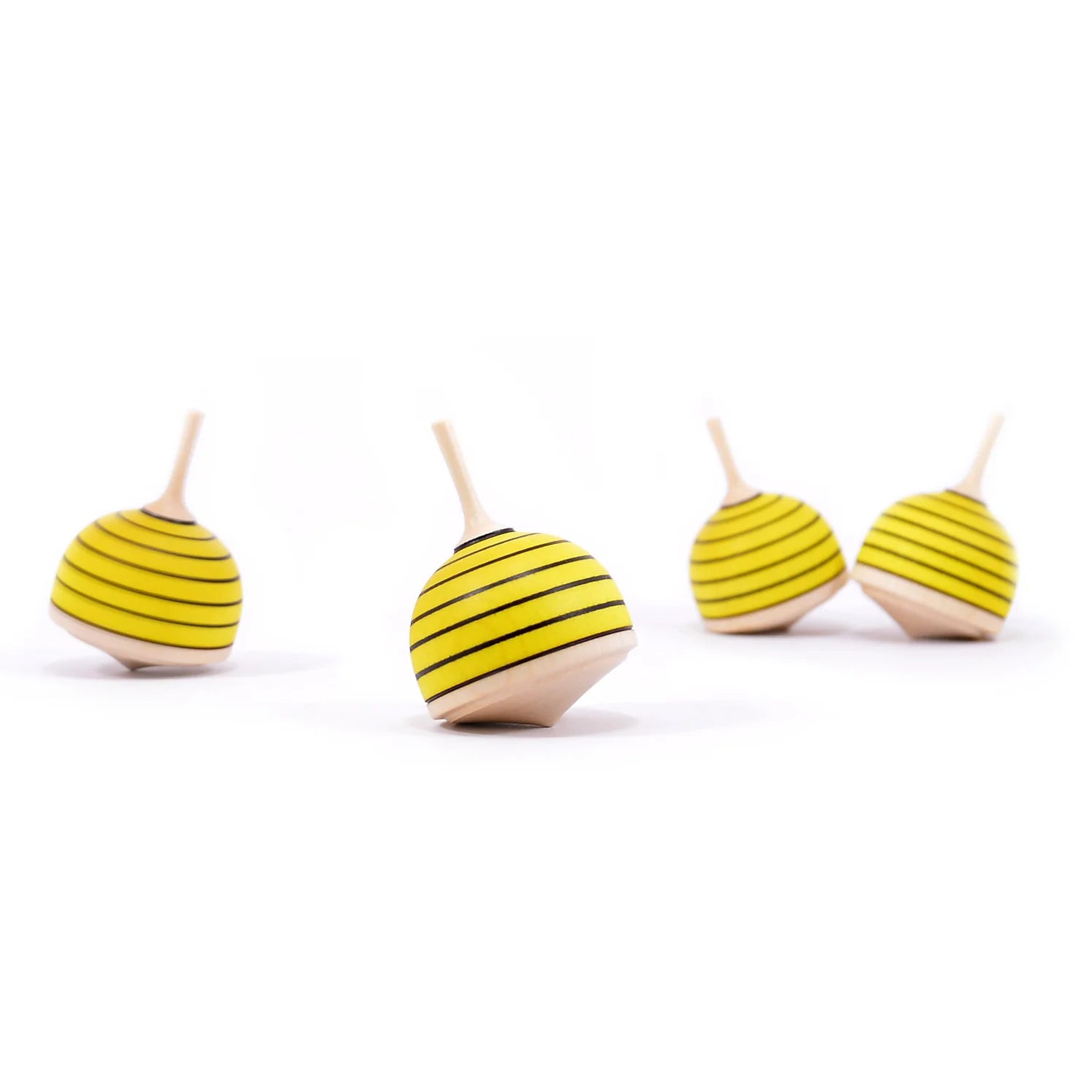 Four wooden toys shaped like bees with striped bodies on a white background