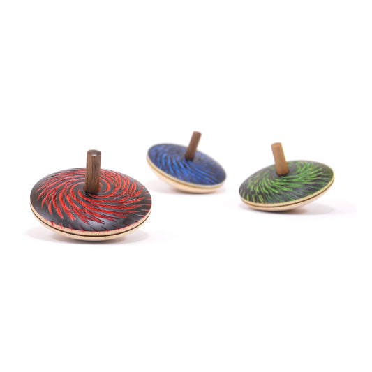 Three wooden top toys with colorful designs on a white background