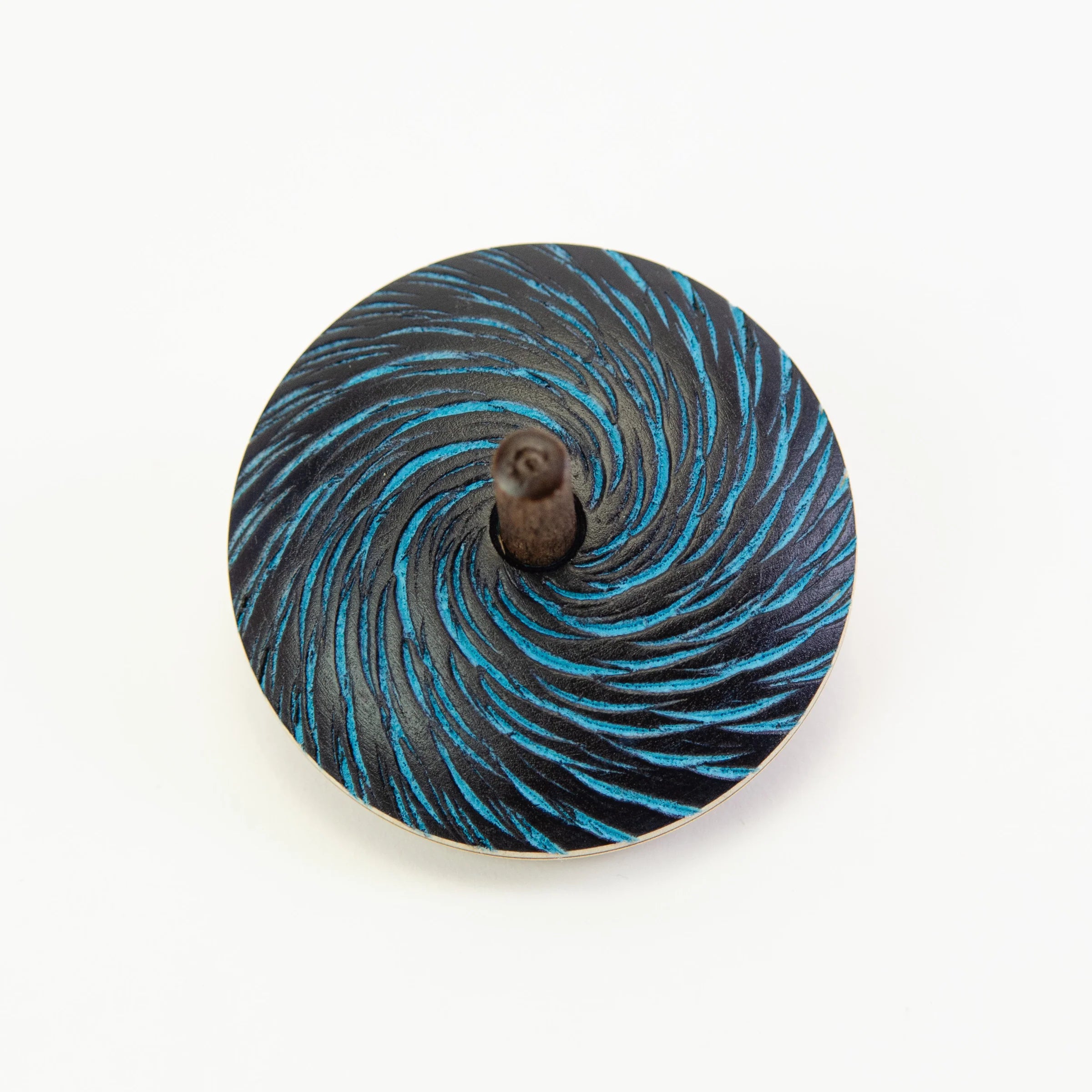 Spinning top with blue and black spiral pattern on a white background