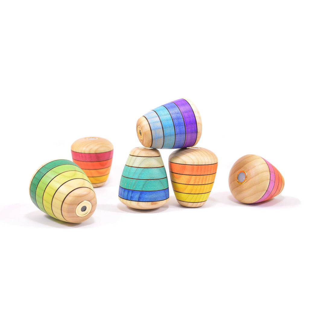 Colorful wooden toys stacked on a white background