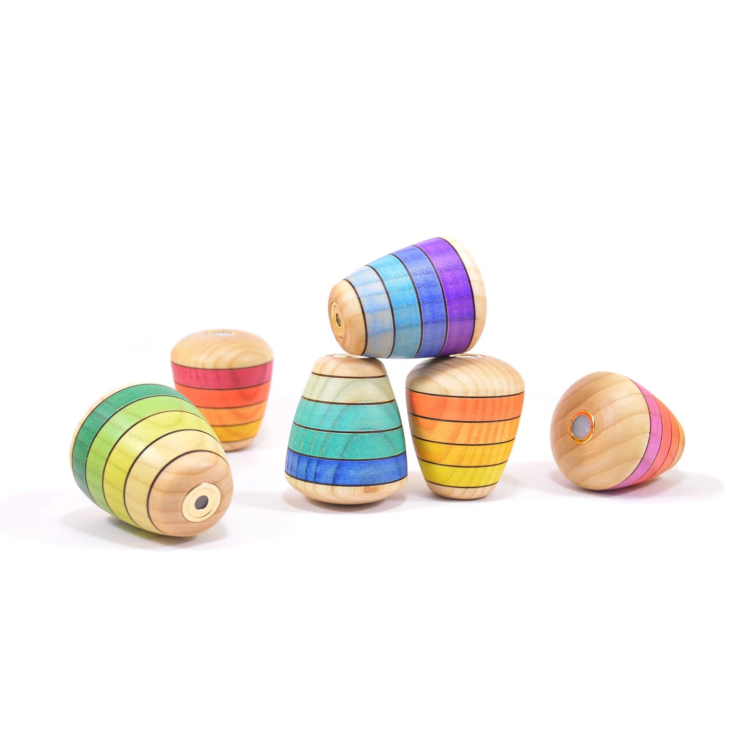 Colorful wooden toys stacked on a white background