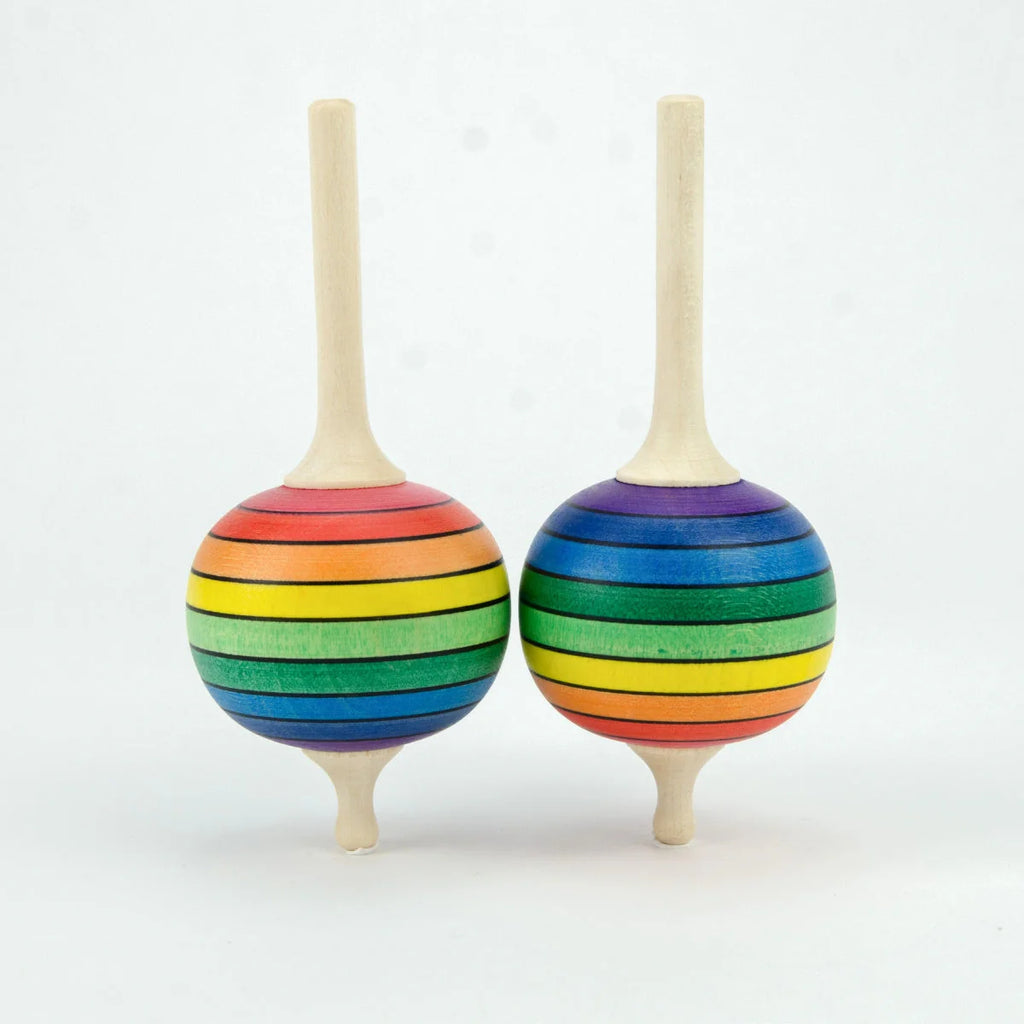 Two rainbow-striped wooden top toys on a white background