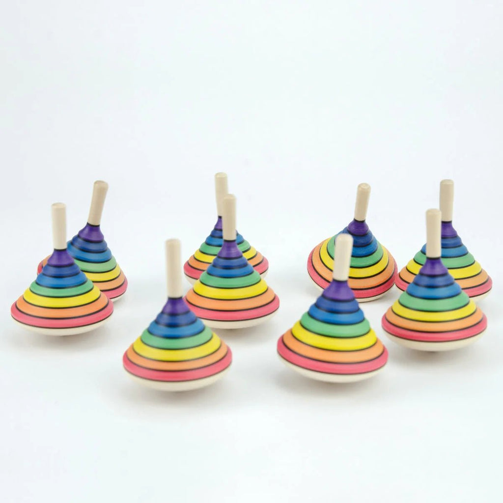 Set of colorful wooden spinning tops on a white background