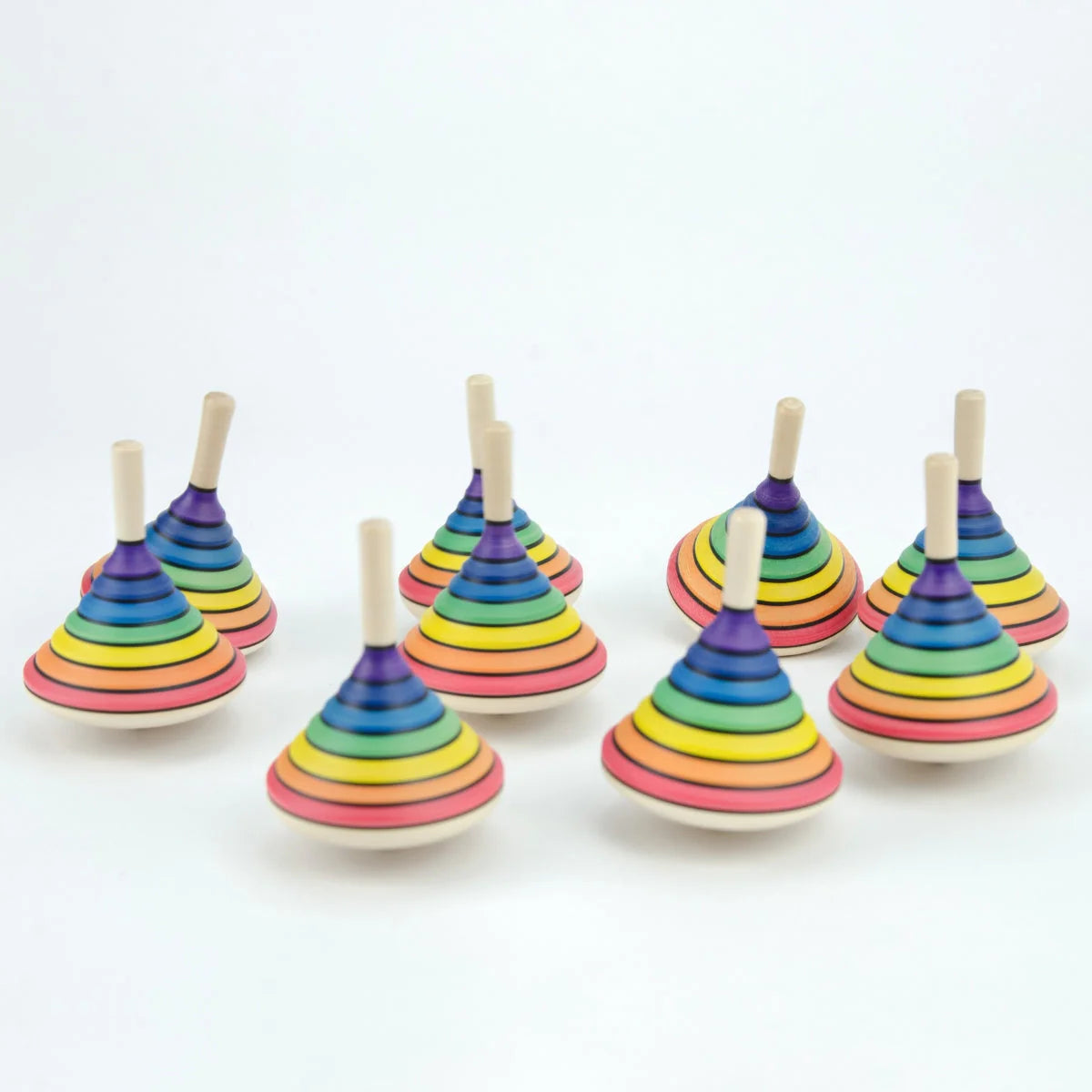 Set of colorful wooden spinning tops on a white background