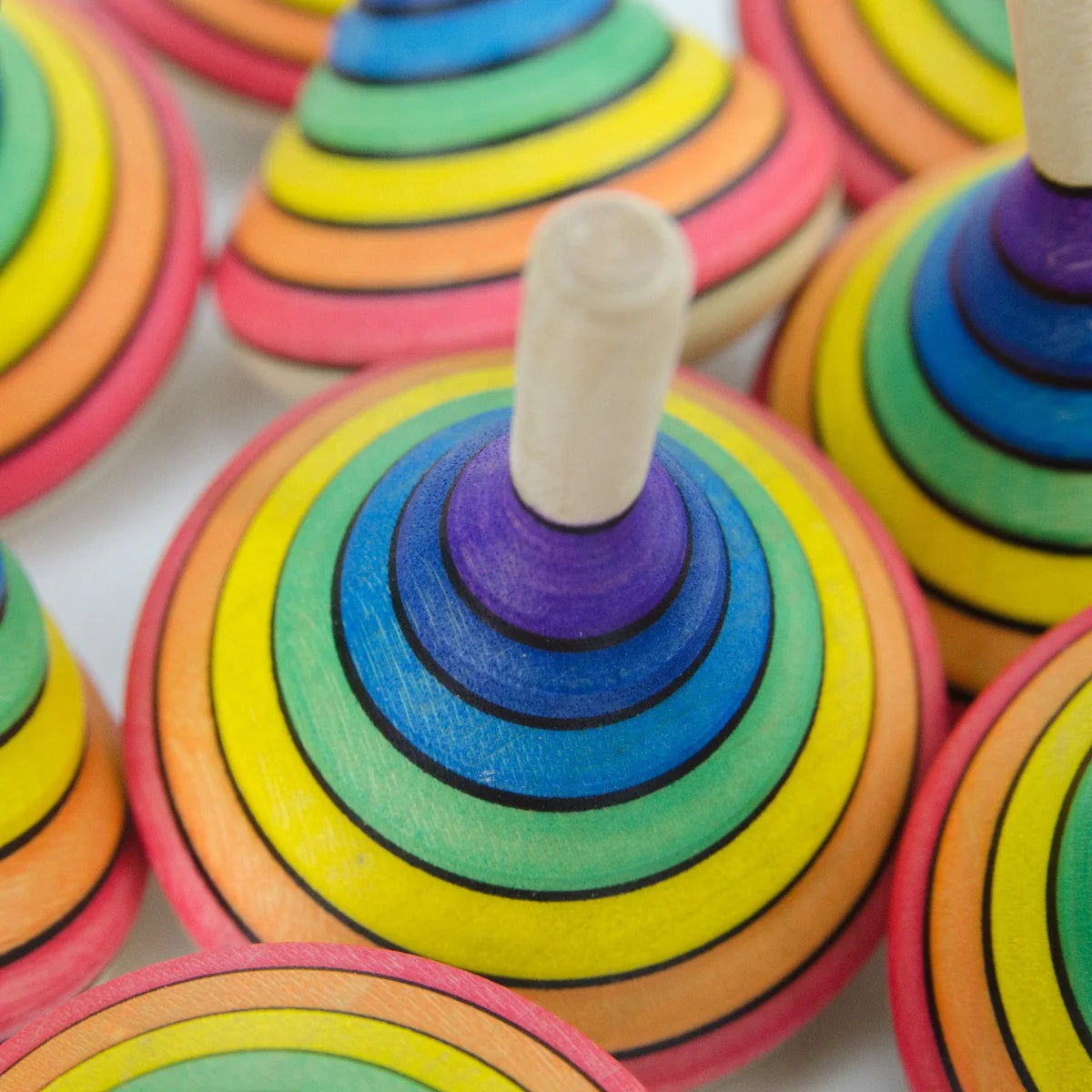 Close-up of colorful wooden ring toys with a white background