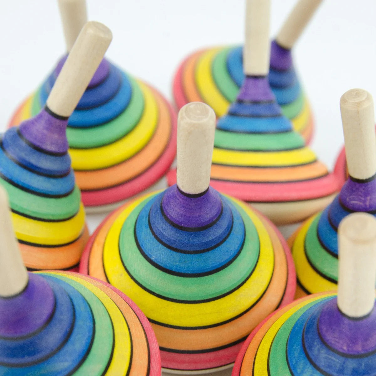 Colorful wooden ring toys on sticks with a white background