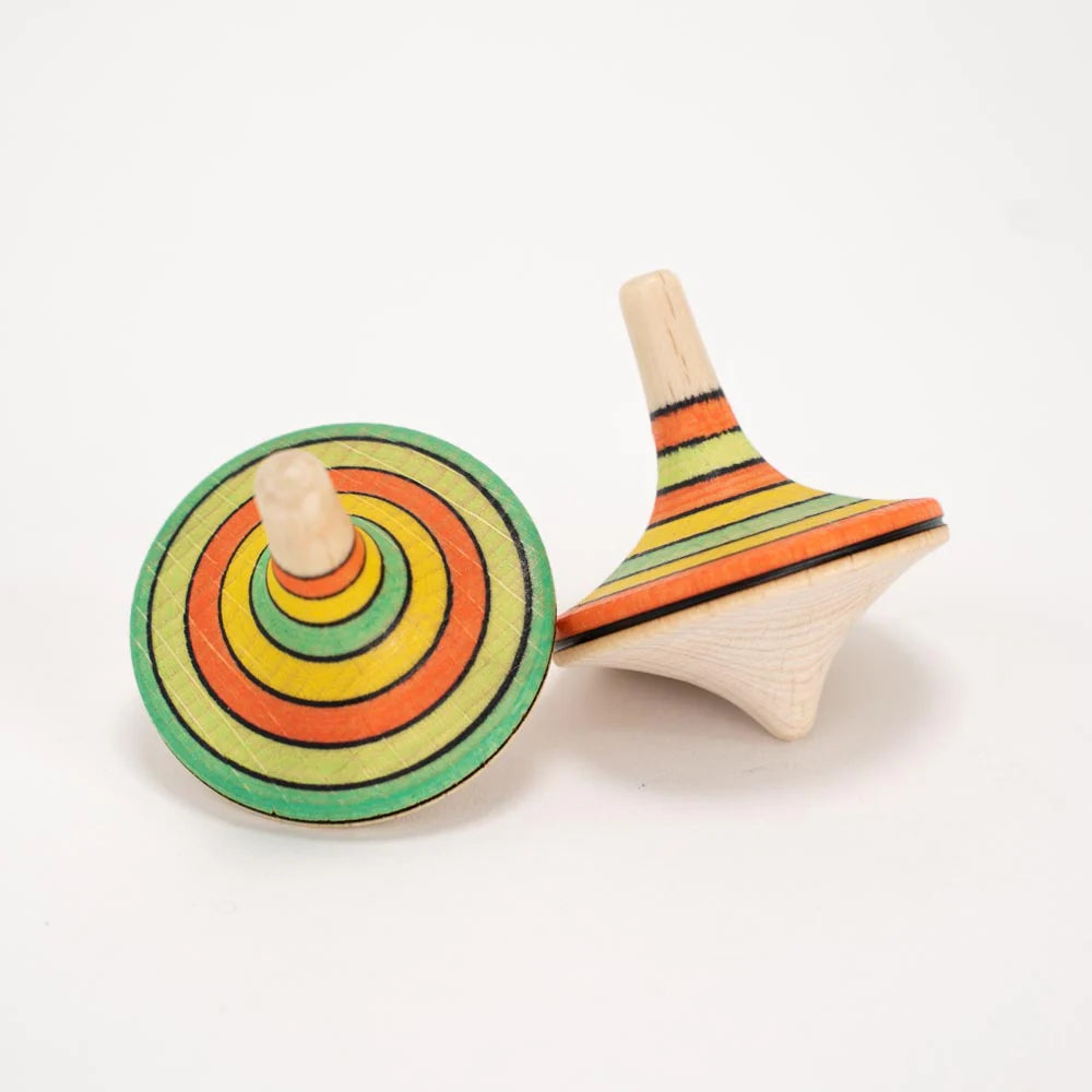 Two wooden spin tops with colorful concentric circles on a white background