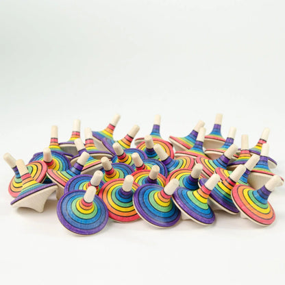 Colorful wooden spinning tops on a white background