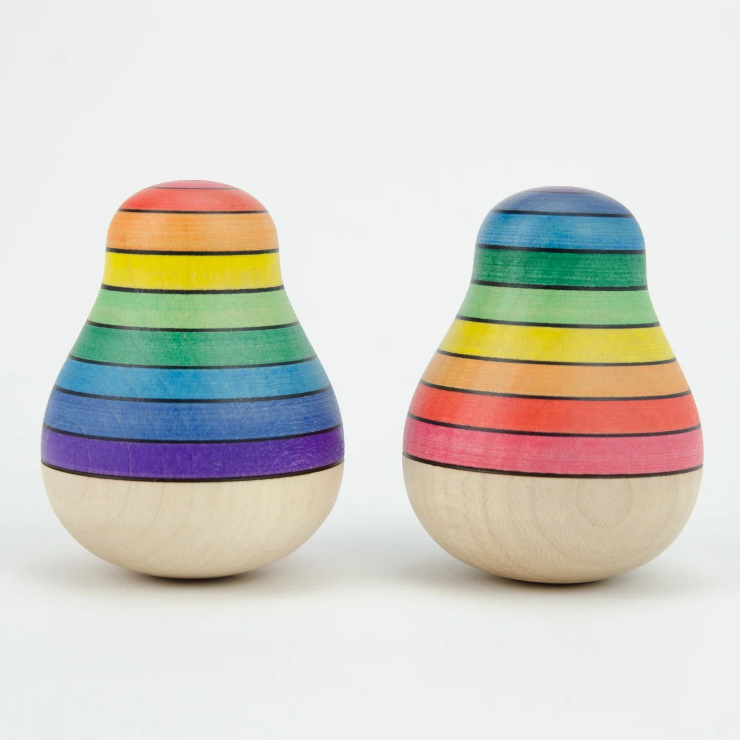 Two wooden toys with rainbow stripes on a white background