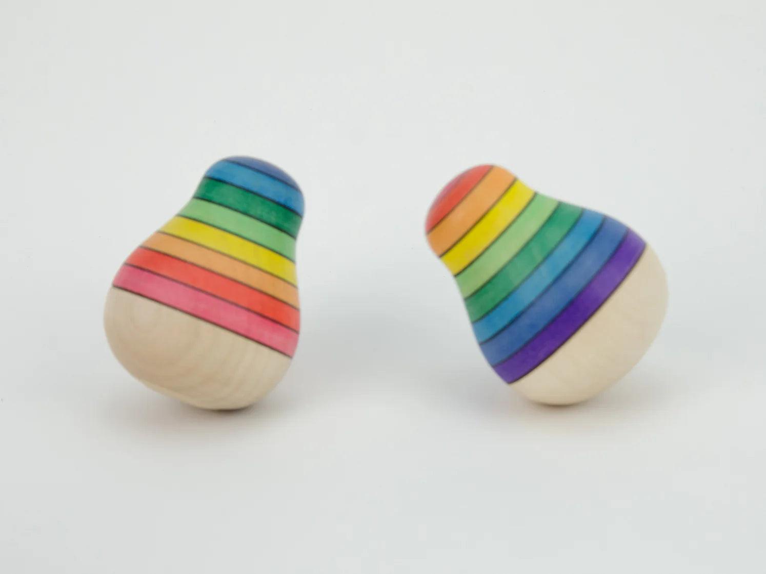 Pair of rainbow-striped toys on a white background