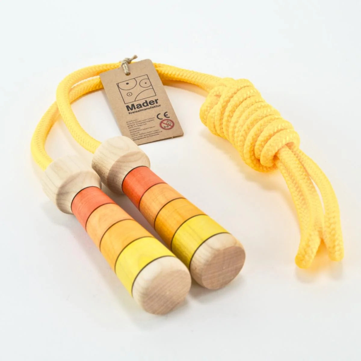 Wooden skipping rope with colorful handles and a Mader label on a white background