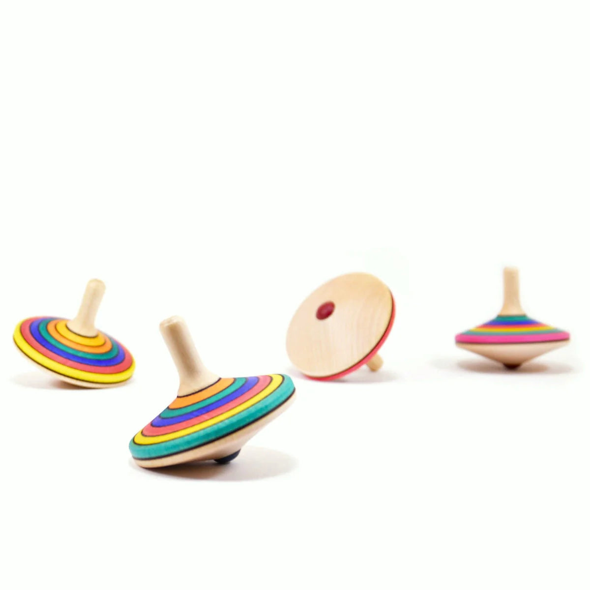 Colorful wooden spinning tops on a white background