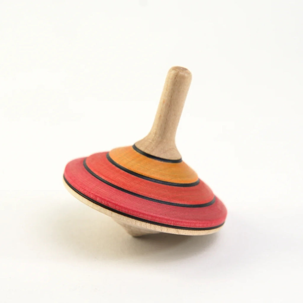 Colorful wooden spinning top on a white background