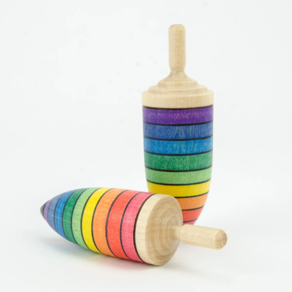 Two wooden toys with rainbow stripes on a white background