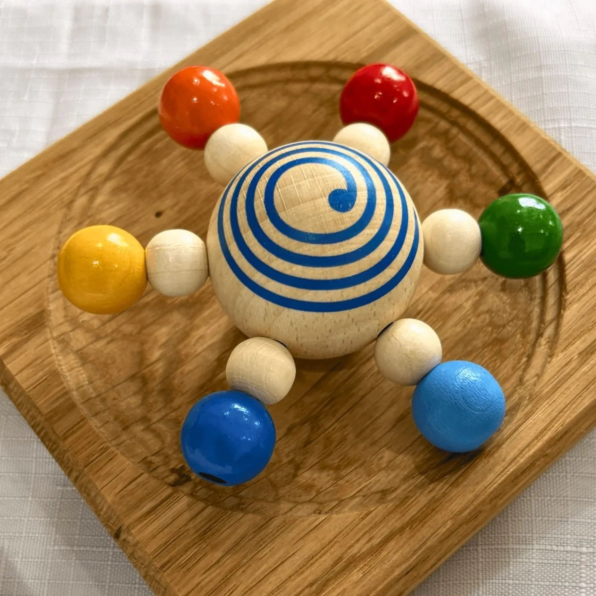 Wooden toy with colorful spheres on a wooden base