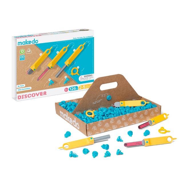 A cardboard construction toolkit with various tools and pieces displayed, including saws, rollers, drivers, and connectors, packaged in a box with a clear plastic cover showing the contents.