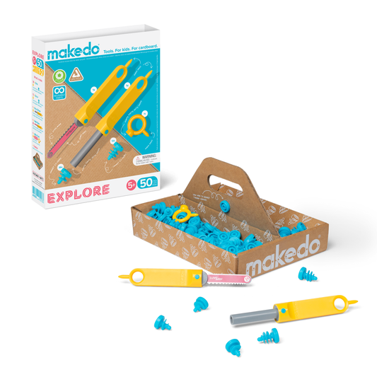 A cardboard construction kit with various tools and pieces displayed, including connectors and saws, packaged in a box with a 'Makedo' logo.