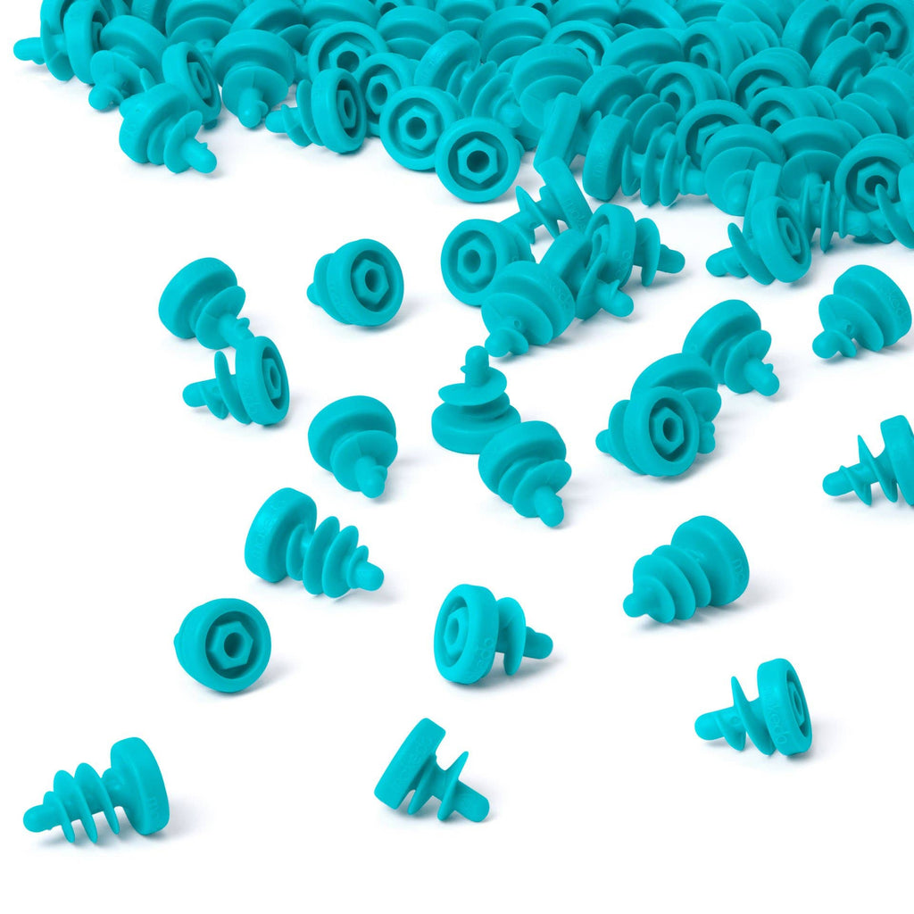 Turquoise silicone earplugs scattered on a white background