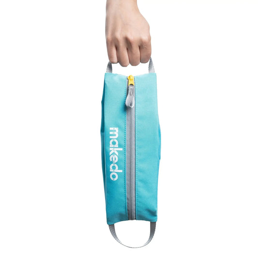 Turquoise bag with a zipper held by a hand on a white background