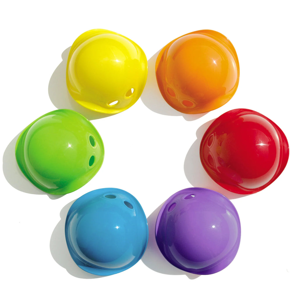 Set of six colorful plastic balls arranged in a circle on a white background