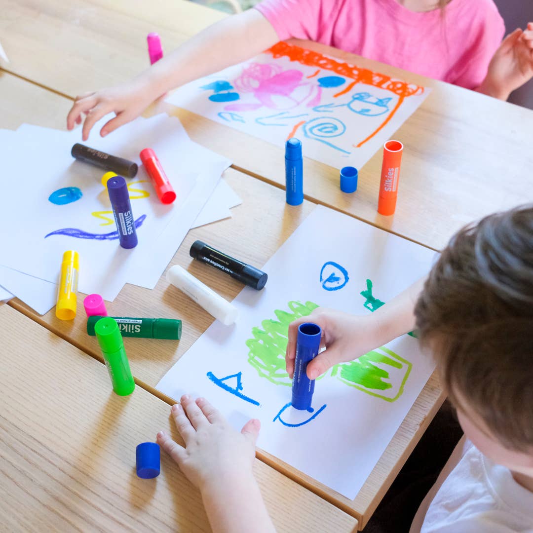 Children drawing on white paper with Silkies