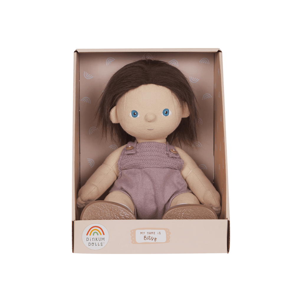 Dinkum Dolls doll in a pink box on a green background