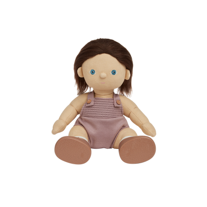 Doll with brown hair and blue eyes wearing a pink knitted romper on a white background