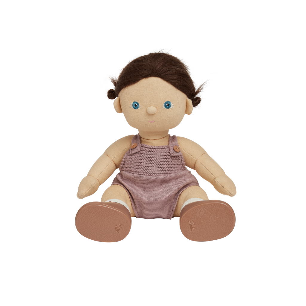 Toy doll with a pink romper on a white background