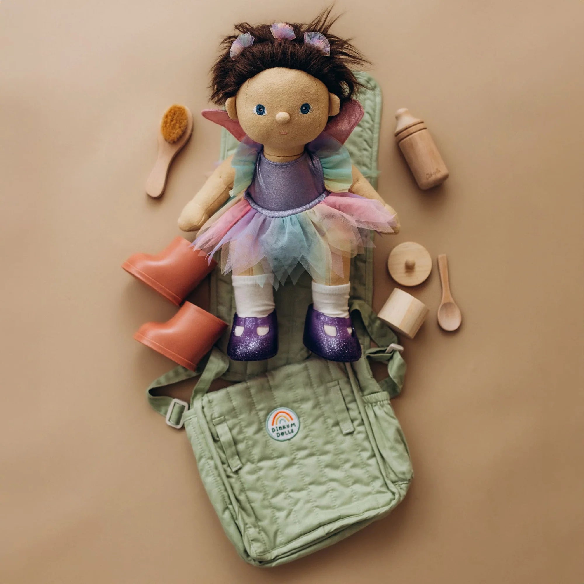 Doll with accessories on a beige background