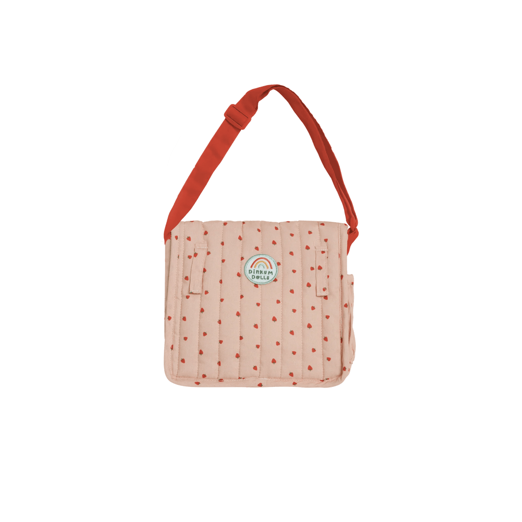 Pink polka dot bag with red strap on a white background