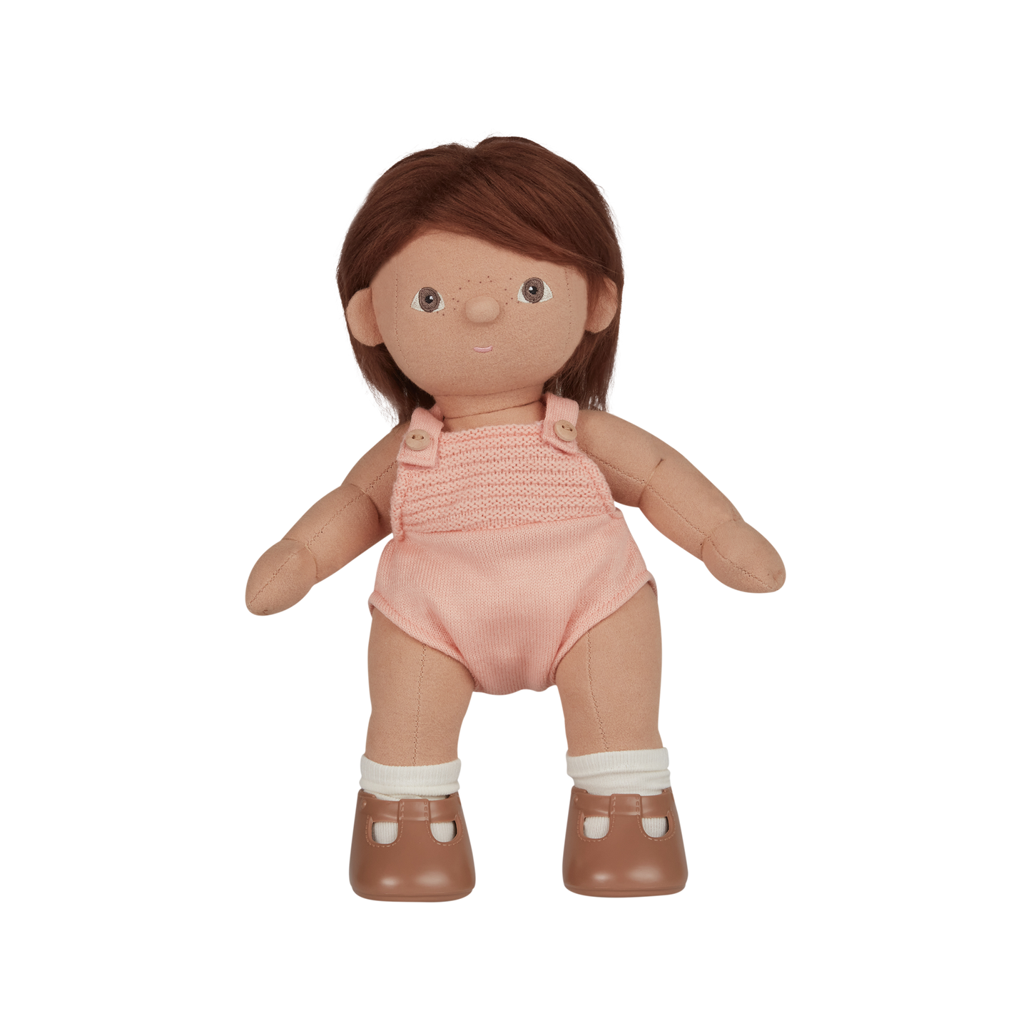 Doll with brown hair wearing a pink romper on a white background