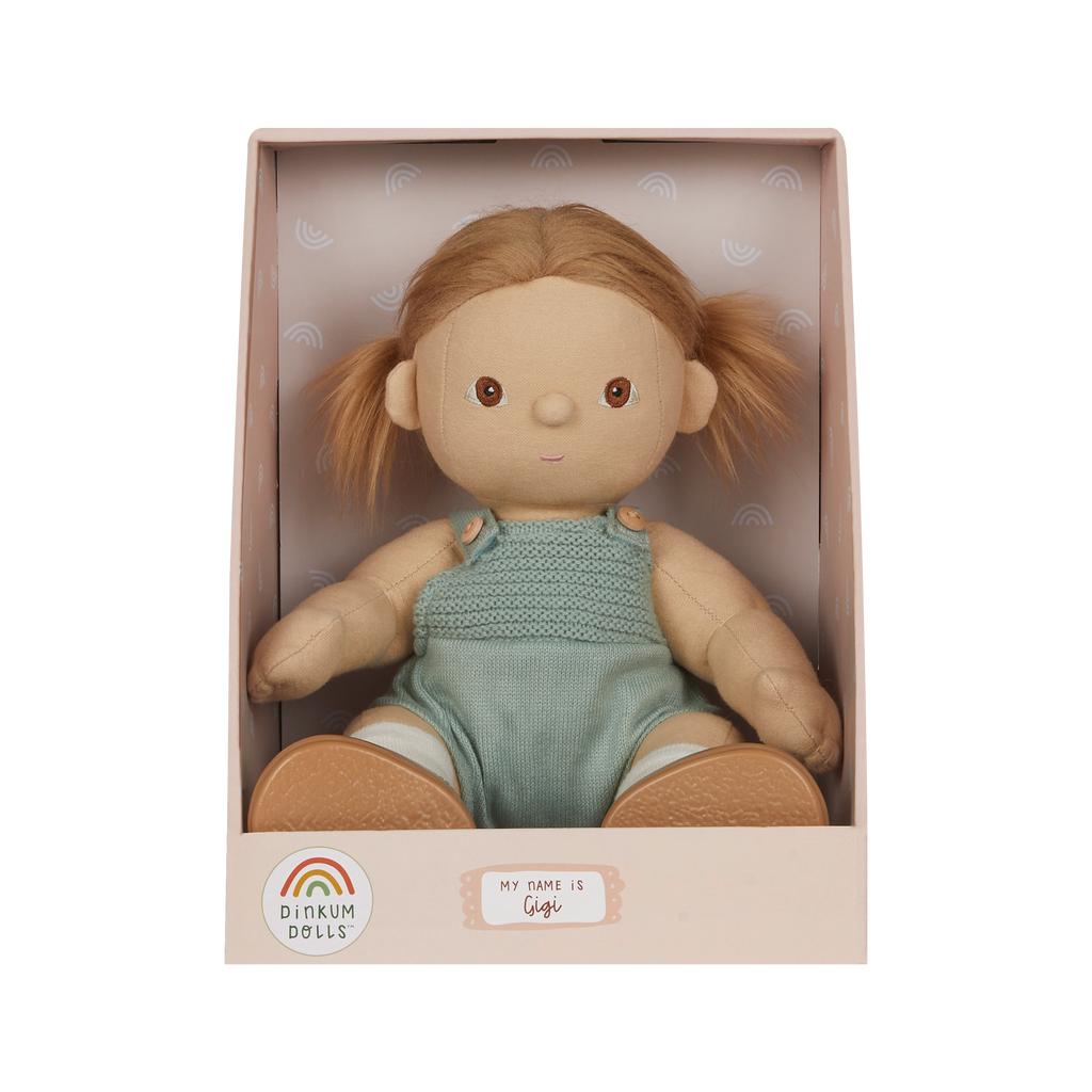 Doll in a box with 'Dinkum Dolls' branding on a white background