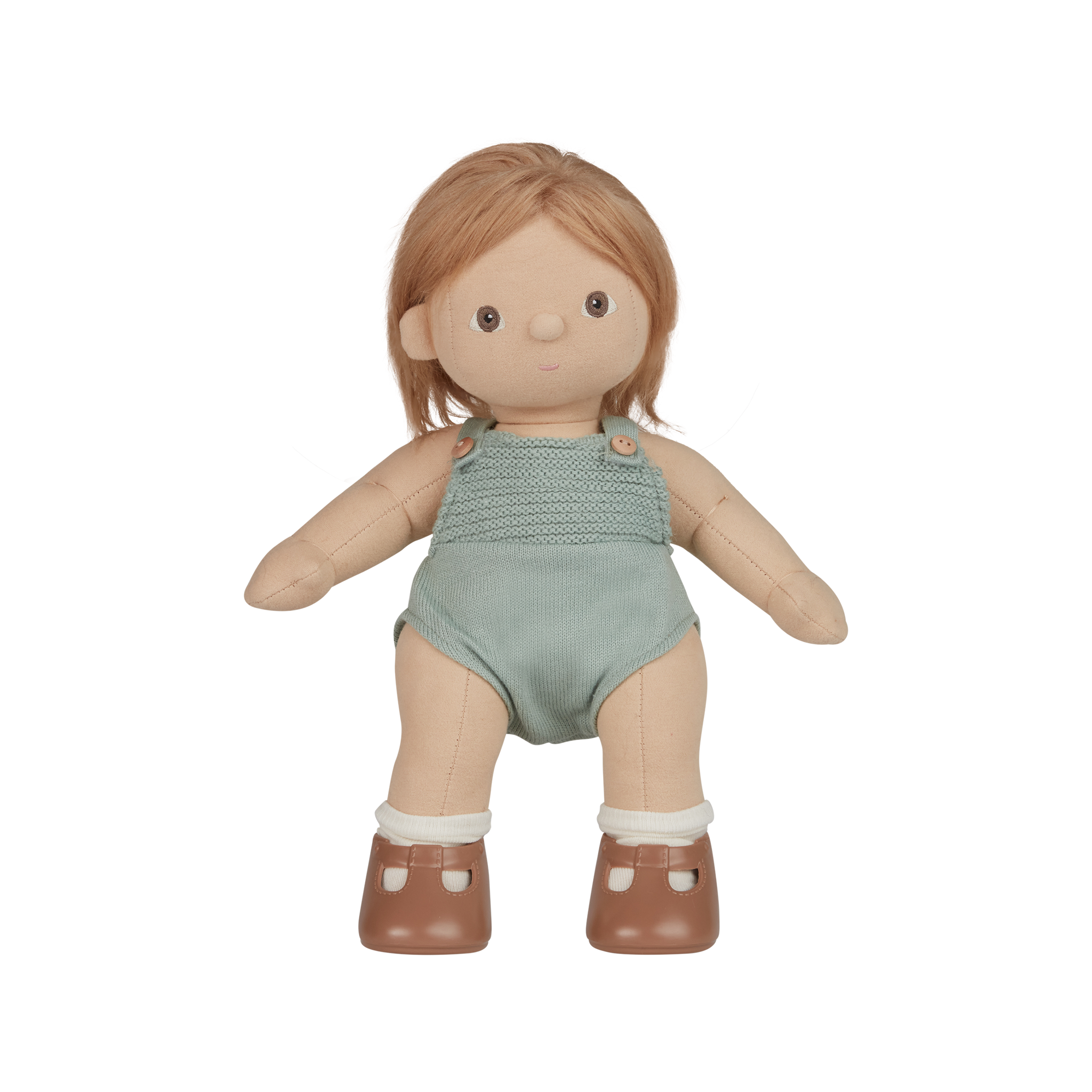 Doll with blonde hair wearing a green romper on a white background