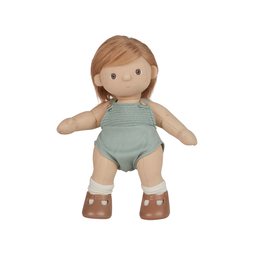 Doll with a green textured outfit on a white background