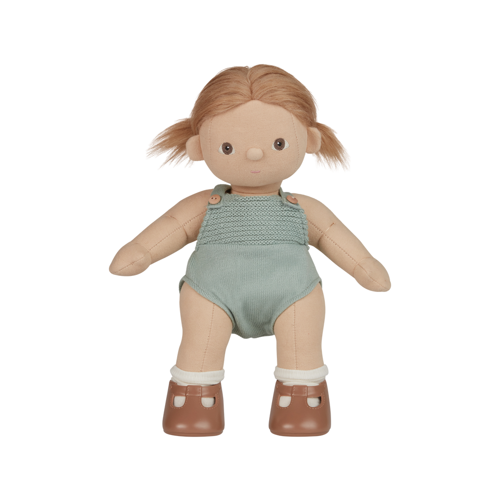 Toy doll with blonde hair wearing a green outfit on a white background