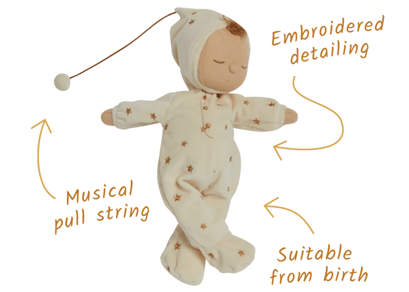 Baby doll in a white outfit with star patterns, featuring embroidered detailing and a musical pull string, suitable from birth.