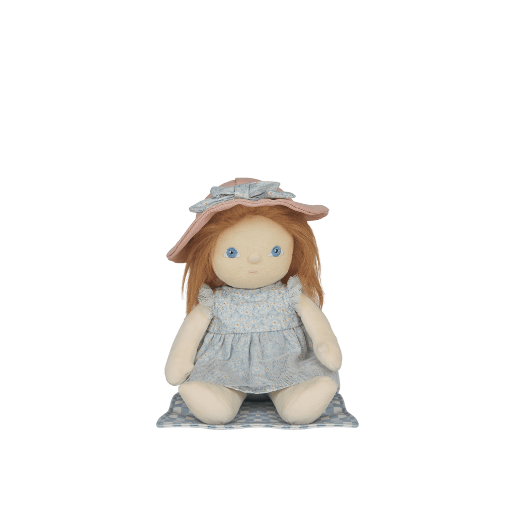 Stuffed doll with a pink hat and blue dress on a white background